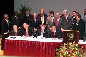 Gov. Robert Bentley signs documents in deal to bring Commercial Jet Inc. to Dothan Regional Airport.