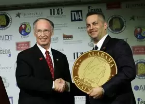 Gov. Robert Bentley presents Remington Outdoor Company Chairman and CEO George Kollitides with an Alabama Great Seal at a jobs announcement in Huntsville, Ala., Monday, Feb. 17, 2014. Remington officials announced they will bring more than 2,000 jobs to Madison County over the next ten years. (Governor's Office, Jamie Martin)