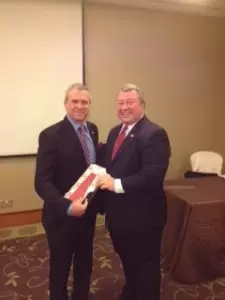 Secretary Greg Canfield, right, presented US Ambassador Kirk Wagar with an Alabama tie.