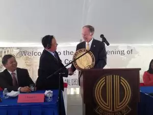 Gov. Bentley presents Golden Dragon Chairman Li Changjie with the state seal at the plant's grand opening. May 28, 2014.
