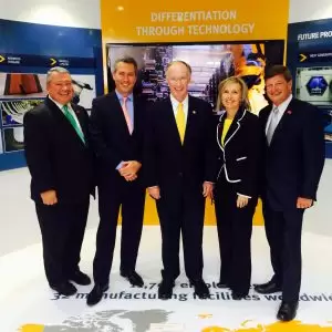 Commerce Secretary Greg Canfield, GKN's Daniele Cagnatel, Gov. Bentley, Elmore County economic developer Leisa Finley, and County Commissioner Joe Faulk at the GKN chalet at the Farnborough Air Show, where the company announced an expansion. (July 15, 2014)