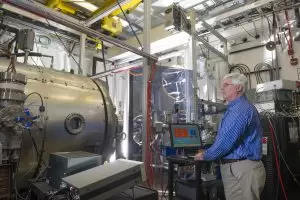 Todd Schneider adjusts the light hitting a sample inside the High Intensity Solar Environment Test system chamber at NASA's Marshall Space Flight Center in Alabama. (Image: NASA/MSFC Emmett Given)