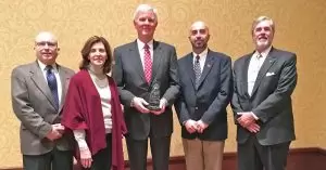 Forrest Wright holds his Dave Echols Award, flanked by SEDA Chairman Steve Hargrove and Executive Committee member Rose Jones. Commerce's Bob Smith is on the far left, while the EDAA's Jim Searcy is on the right.
