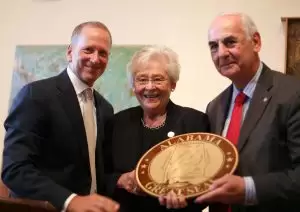 Governor Kay Ivey presents leaders of Conecuh Ridge Distillery with a plaque of the Great Seal of Alabama after the company announced plans to consolidate its operations in Troy. (Image: Governor's Office, Syndey A. Foster)
