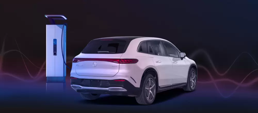 Electric Mercedes-Benz GLS SUV beside a charging station.