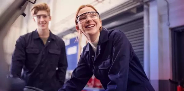 Two students working in an automotive training center.