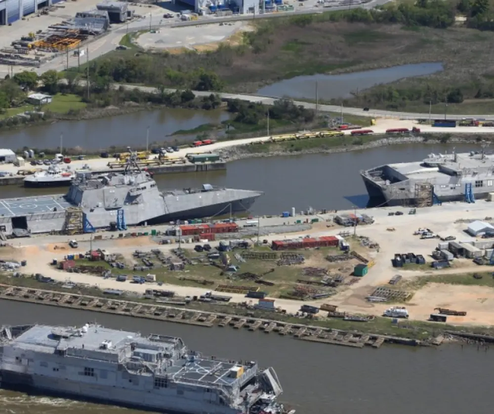 An areal view of the Austal ship yard, featuring several combad ships.